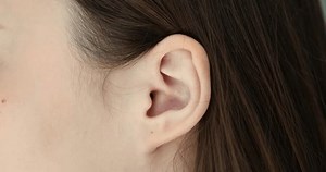 Closeup of woman face and ear concept. Structure and operation of the human auditory analyzer