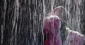 Wet woman in lingerie sensual moves standing in the rain. Water drops flowing down the body of a beautiful girl. Slow motion