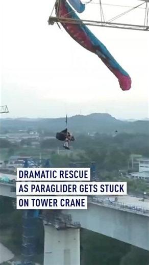 Dramatic rescue as paraglider gets stuck on tower crane
