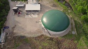 Biogas plant and farm in park or green space in Toronto, Canada. Renewable energy from biomass such as organic food waste and zoo manure. Storage tank for biogas and power produce.