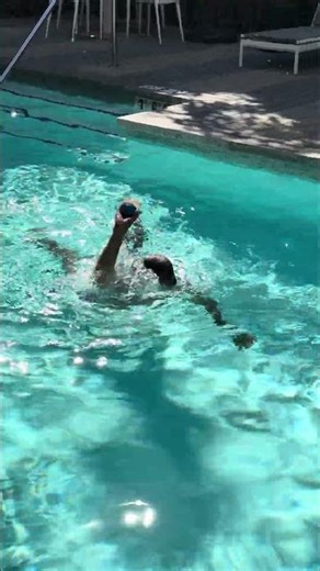 Attempting to Throw a Ball, Submerged in a Swimming Pool.