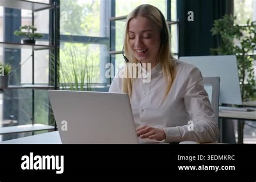 Happy smiling Caucasian business woman talking with client in headset businesswoman female girl helpline operator talk consulting advising work job with laptop working help line chatting in office Stock Video Footage - Alamy