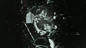 Super Slow Motion Shot of Real Bullet Glass Break Isolated on Black...