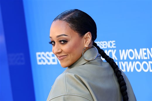 Tia Mowry's Mystery Man Revealed After Packing On The PDA In Viral Smooching Snaps