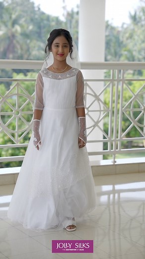 Make her special day even more magical with an exquisite holy communion gown, meticulously crafted for your precious princess. Let her radiate purity and grace as she takes her first steps on a journey of faith and devotion. #HolyCommunion #Baptism #Christening #FirstCommunion #JollySilks #WhiteGown | Jolly Silks