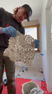 Part 1 of the pebble tile install 🪨 Starting the accent wall and the floor around the freestanding tub. This tile is slow but worth it. More coming soon. #BathroomRenovation #TileWork #HomeRemodel | KLK Builds