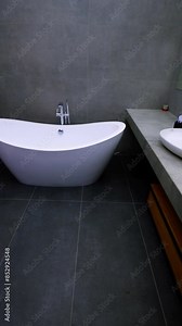 Bathroom and washbasin inside made of marble. Walls are lined with ceramic tiles. White Toilet Interior Template with Toilet and Chest of Drawers Vertical video