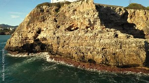 flying a drone over a Bay and lighthouse in Portocolom Majorca Spain