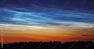 Noctilucent clouds in the night sky, extremely high altitude clouds that appear around the north regions