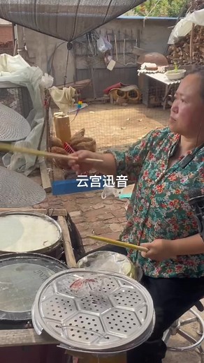 Traditional Drum Playing in a Rustic Outdoor Setting