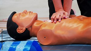 Medical specialist is demonstrating a technique of a cardiopulmonary resuscitation on a medical training