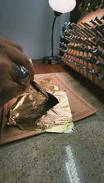 laying some gold leaf on tooled leather!