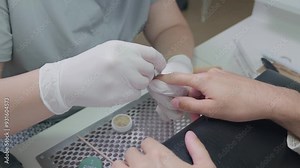 Japanese Manicure process for male nails in a beauty salon close up. Professional manicurist in gloves rubs nutrients into nails. Concept hand care technique with natural materials and compositions