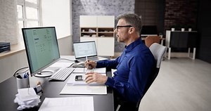 Accountant Using E Invoice Software At Computer In Office