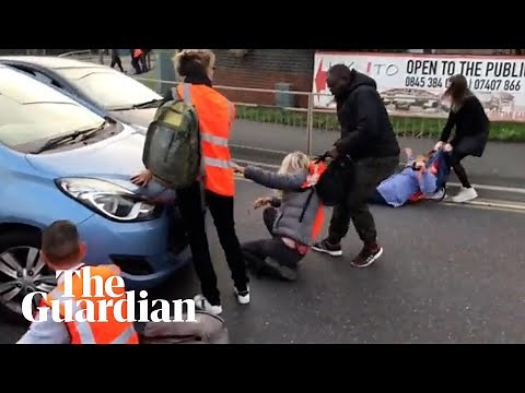 Furious drivers haul Insulate Britain protesters from road junction