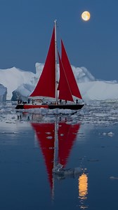 Daniel Kordan | Magic of red sails in Greenland. Join our 2026 photography tours - link in bio. 📸: @raymond_hoffmann #greenland | Instagram