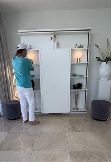 Compact Wall Bed with Revolving Bookcase Design