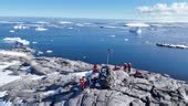 Antarctica icy landscape expedition group tourist traveler people...