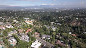 Mansions with stunning views at Encino Hills, California - rising aerial reveal