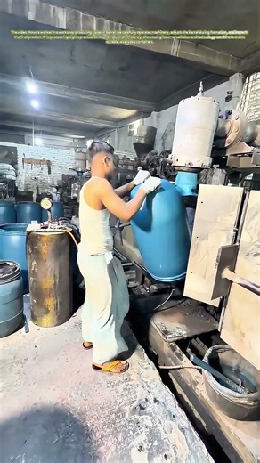 Molding Mastery: How a Worker Crafts Plastic Barrels in a Workshop