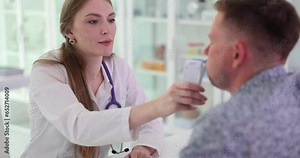 Doctor gives a patient abreathalyzer to measure blood alcohol levels. Driver alcohol testing