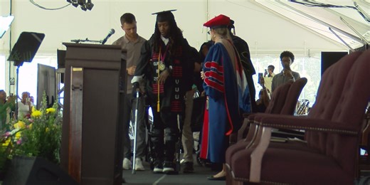 College student who suffered paralyzing spinal injury crosses graduation stage using robotic exoskeleton
