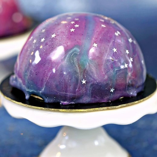 GALAXY MOUSSE CAKES - mini chocolate mousse cakes on a brownie, with THE MOST GORGEOUS galaxy mirror glaze on top! 🌌🌌 Learn how to make it! --> http://www.sugarhero.com/galaxy-mousse-cakes/ #ad | SugarHero Dessert Recipes