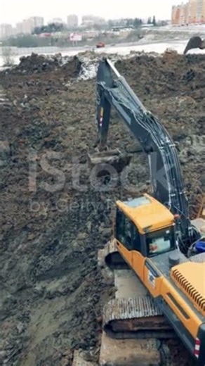 Soil is getting scooped by the excavating machine