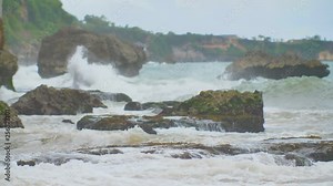 Slow mtion stony and rocky shore with strong waves and wind near Bali island. Tegal Wangi beach. Indonesia.