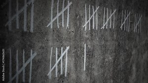Counting days in Prison on a concrete wall
