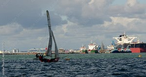 Sailor Trapezing from a Isometric Sailing dinghy at Calshot spit, the Solent, Southampton