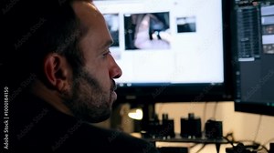 tracking shot from behind video editor or slow tracking shot around video editor or focused video editor tracking shot