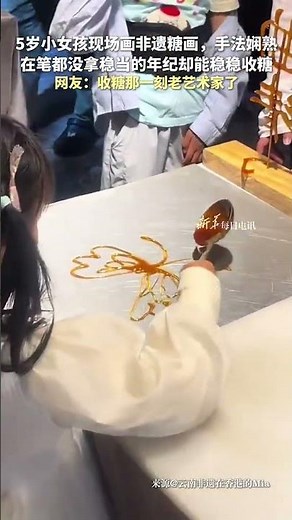 A 5-year-old girl wows the crowd as she creates an intricate sugar painting.