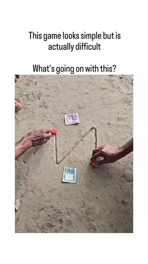 👁️ on Instagram: "The post features a 13-second video of an Indian street challenge using a string looped between red caps and sticks to lift 10-rupee notes from sandy ground without direct touch, appearing simple but proving frustratingly precise in timing and angle. Viewer replies in Japanese emphasize the game's deceptive difficulty, with one astutely observing the man intentionally fails initial tries to encourage his partner before succeeding, revealing a staged, affectionate dynamic. From