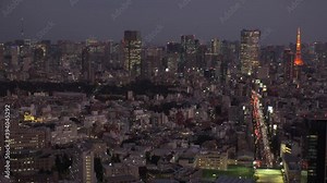 TOKYO, JAPAN : Wide aerial high angle sunset CITYSCAPE of TOKYO. View of buildings around Roppongi from Shibuya. Japanese city life and metropolis concept. Time lapse zoom out shot dusk to night.