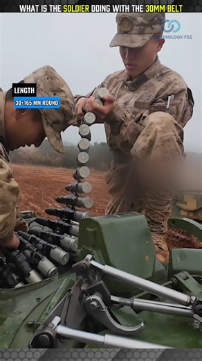 WHAT IS THE SOLDIER DOING WITH THE 30MM BELT