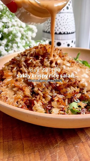 Kate Phillips | Dished by Kate on Instagram: "The viral crispy rice salad, but make it satay 😍 Because everything is better with this insanely, drinkably good creamy peanut satay dressing and that is 100% the case here 💅 I’m posting a recipe every day for 100 days and this is day 36! If you’d like me to send you a link to the full recipe, you can comment ‘send recipe’ below and I’ll pop the link into your DMs 😊 Or, you can find it on dishedbykate.com (linked in my bio) or