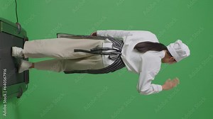 Full Body Of Back View Asian Woman Chef Walking On Treadmill And Waving Hand In The Green Screen Background Studio