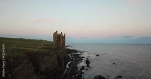 4k aerial fly past of Old Keiss Castle near Wick, Caithness, Scotland. On the route of the North Coast 500 tourist trail.