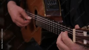 Close-up of an Italian man playing in the church on a guitar