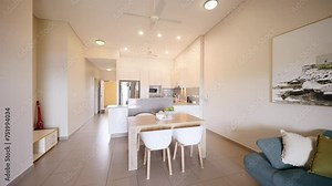 Push In Establish Past Blue Couch and Small Square Table to Rectangular Hallway Floorplan with Vacuum and Staged Decor. Interior of house home for real estate property.