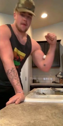 Guy tries to crack an egg with his bicep, farts, and drops the egg.