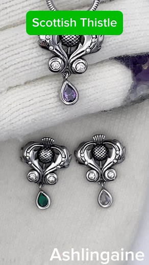 Bold and beautiful large Scottish Thistle CZ Pendant with optional Chain/cord Our breathtaking and Regal Scottish Thistle Stone Necklace is full of details, including a teardrop CZ at the bottom of the pendant. A striking three-dimensional Scottish Thistle is surrounded by four Small cz stones and four larger ones among the lovely large leaves, creating a heart shape. Detailing in the leaves, Thistle is accented with black antiquing to add to the overall beauty of the pendant. This one will be a