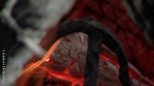 A Red Hot Branding Iron on the Fire for Livestock Branding in the Farm. Close Up.