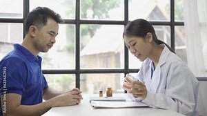 Young Asian dentist explaining patient's endodontic treatment, discussing dental treatment plan in dental clinic office - dentist consultation concept