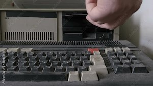 Old pc look. View of a close-up of inserting and removing an old-style 5.25" floppy disk