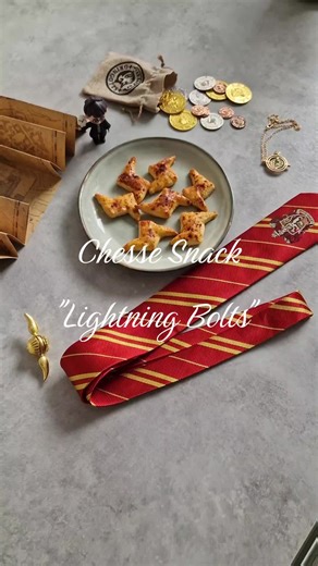 #harrypotter #hogwarts #lightningbolt #griffyndor🦁 #privetdrive Cheese Snack “Lightning Bolts” Makes about 20–25 pieces PREP TIME: 40 minutes BAKING TIME: 12–15 minutes These miniature savory snacks are shaped like Harry Potter’s famous lightning-bolt scar, which he unwillingly received after Lord Voldemort’s attack when he was just a baby. Cheesy and satisfying, they can be a tasty lunch, a treat with tea, or perhaps a snack to nibble on while doing homework. You wouldn’t want to end up in Pro
