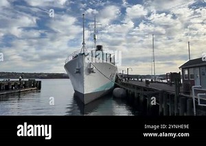 HMCS Sackville, an old naval ship docked in port, at the Maritime Museum in Halifax, Nova Scotia, Canada. Captured in high-quality 4K footage.