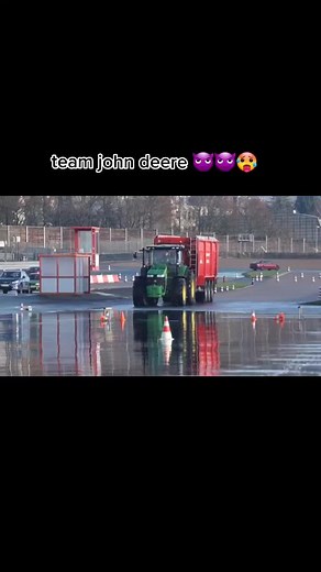 John Deere Tractor Pulling Dump Truck on Wet Surface