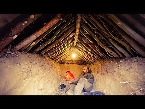 Underground Bushcraft shelter, Wilderness survival shelter, Warm shelter with fireplace in winter